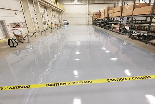 Glossy white floor with caution tape at JBLM Parachute