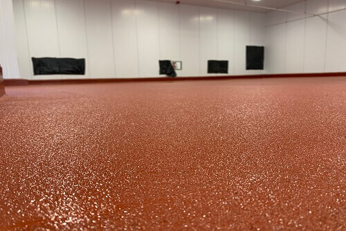 Empty room with red concrete floor